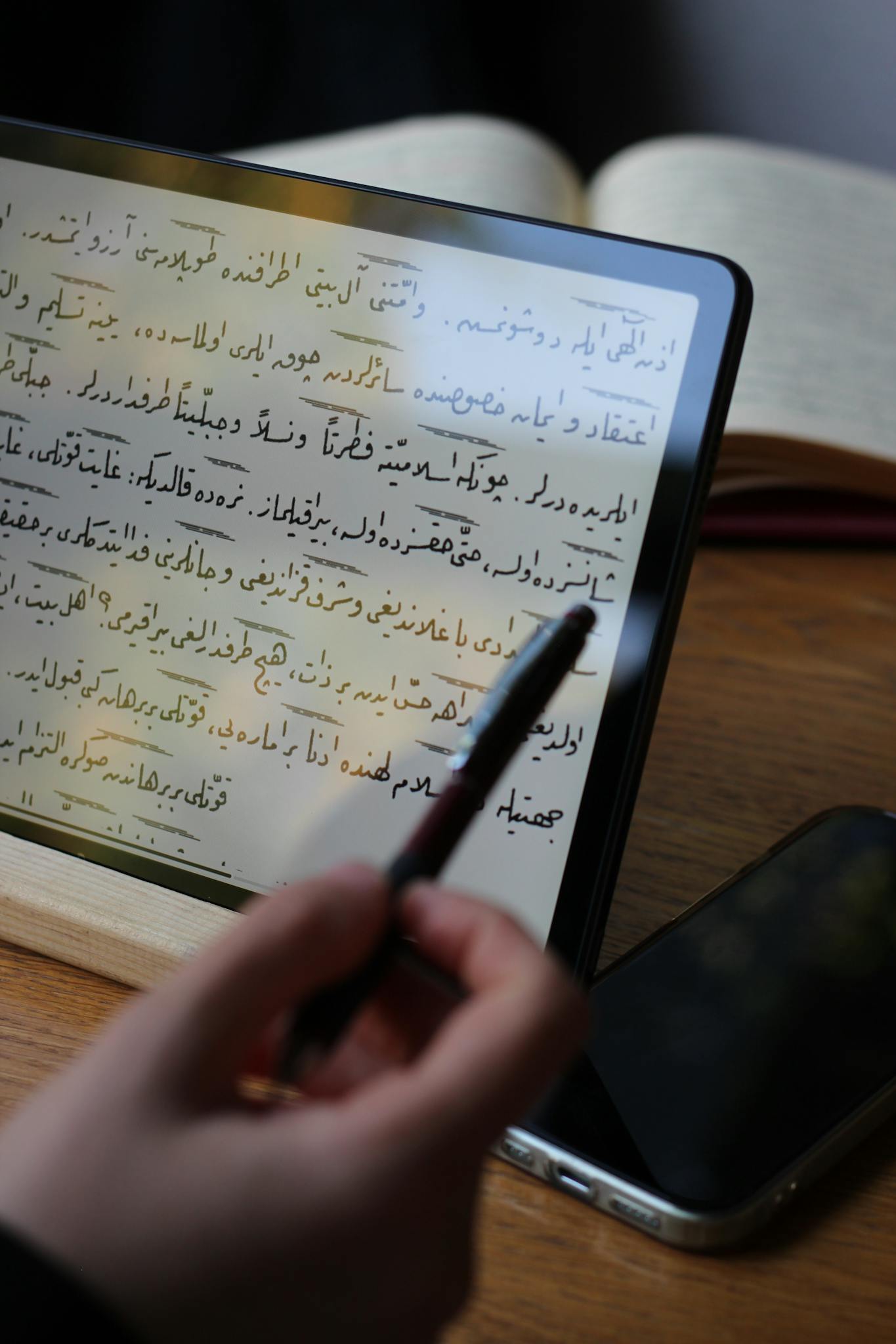 A person is using a tablet to read the quran